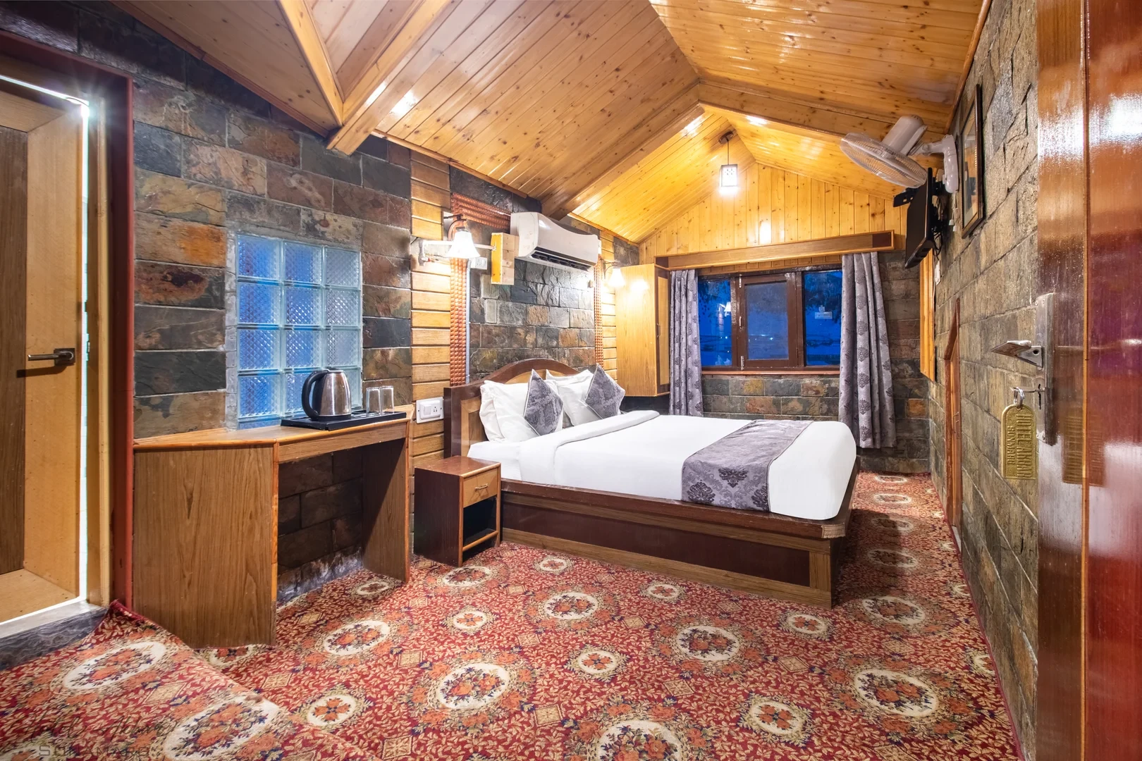 Elegant Sonamarg hotel bedroom interior view.