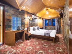 Elegant Sonmarg hotel bedroom interior view.