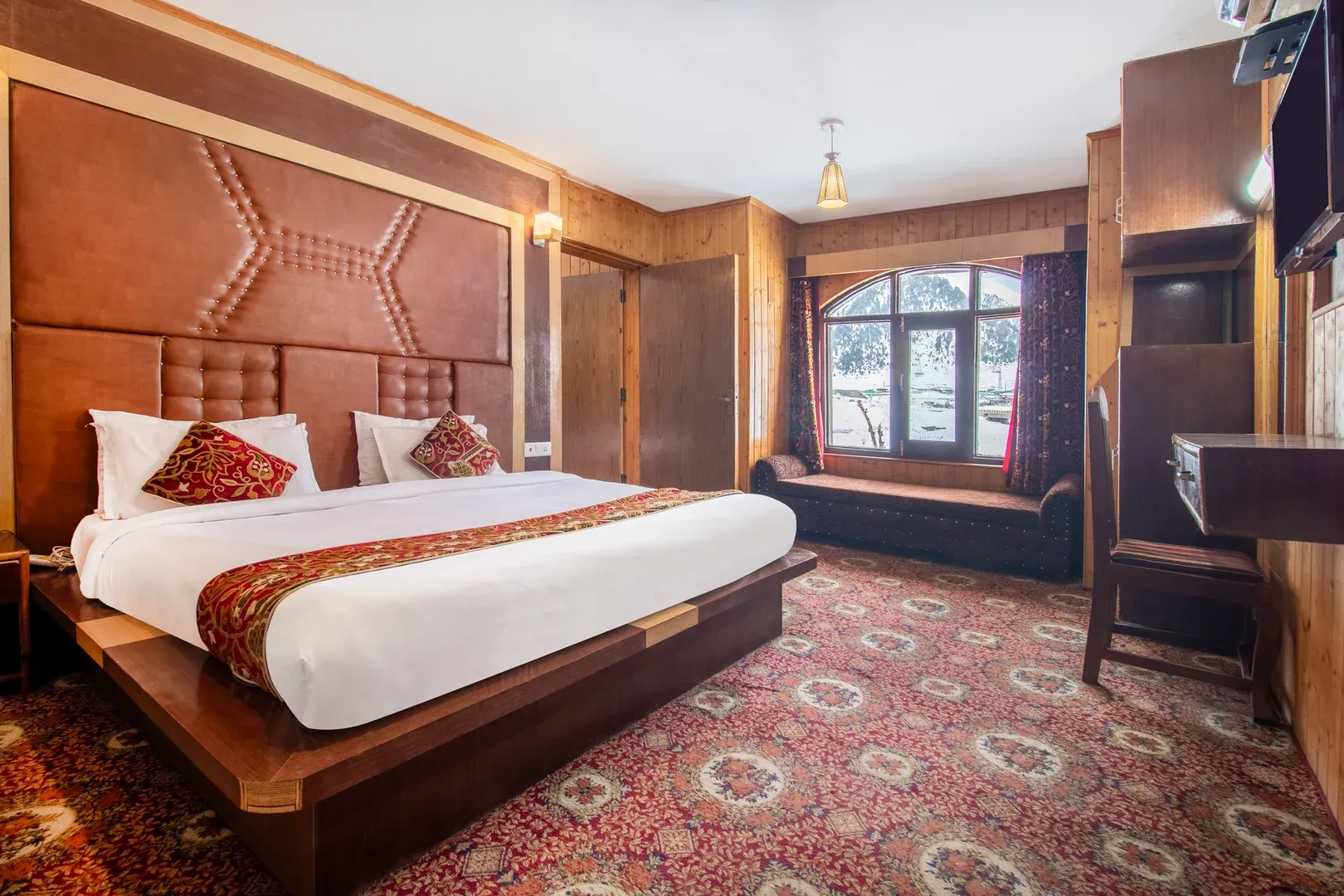 Luxurious hotel bedroom with large king bed.