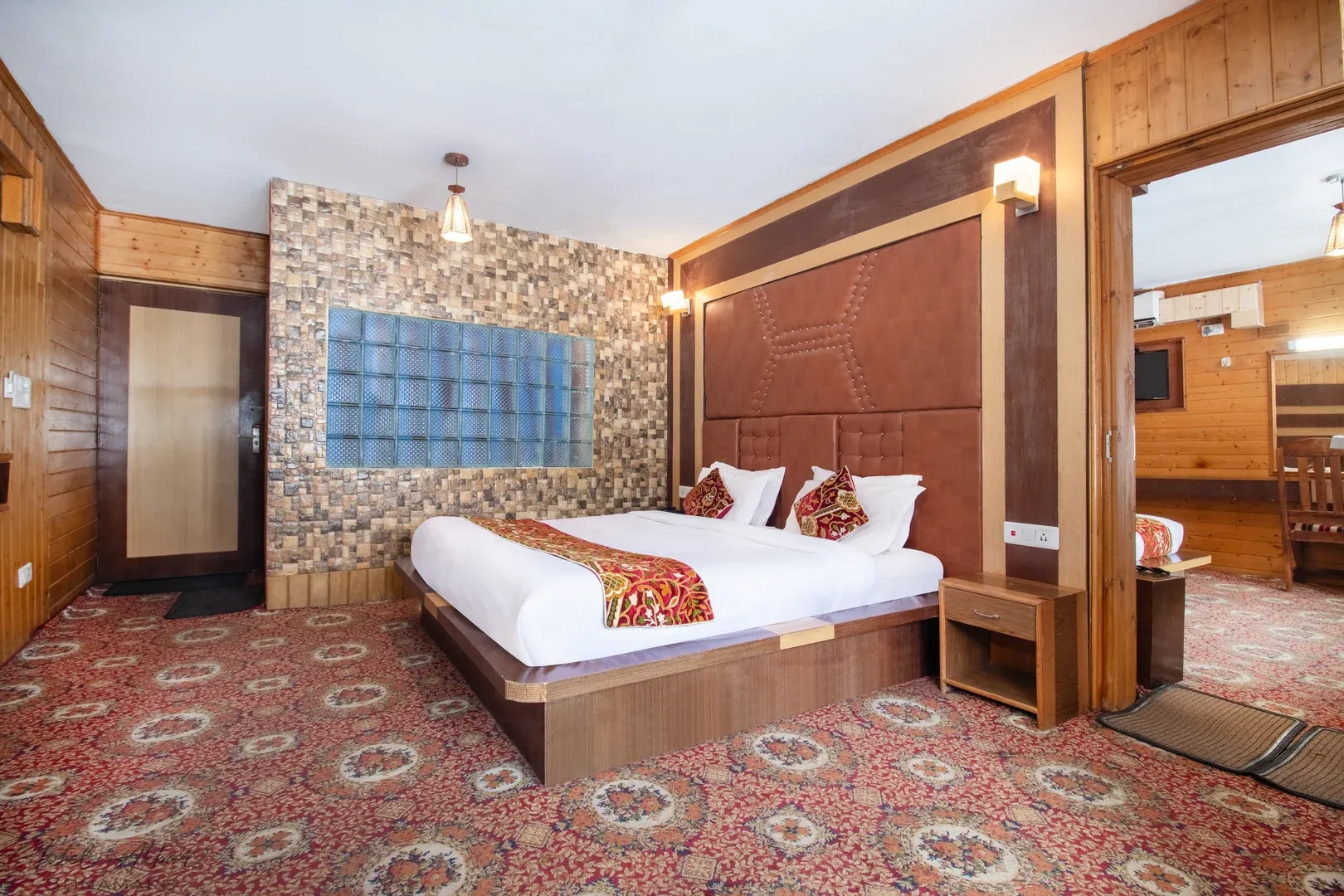 Luxurious Sonamarg hotel bedroom interior view.